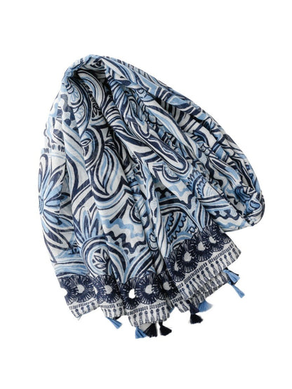 Close-up of blue scarf fabric showing woven texture and tassels