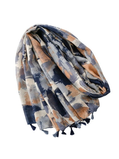 Close-up of Scarvii scarf fabric showing abstract brushstroke pattern and tassels