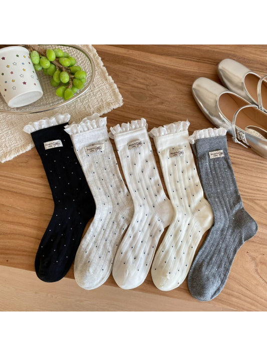 Close-up of ribbed texture and polka dot pattern on beige socks