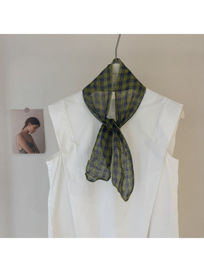 Scarvii skinny scarf draped over a chair showing gingham and stripe details