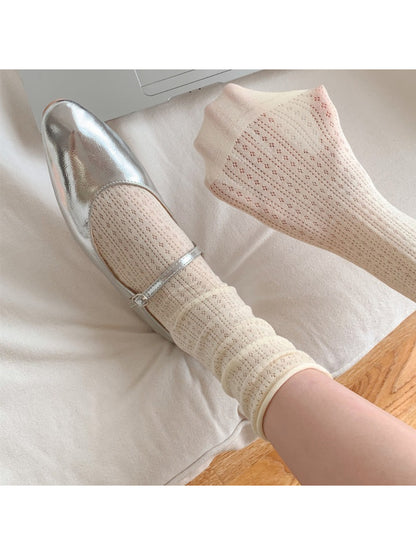 Rufia crew socks in beige displayed on a wooden surface