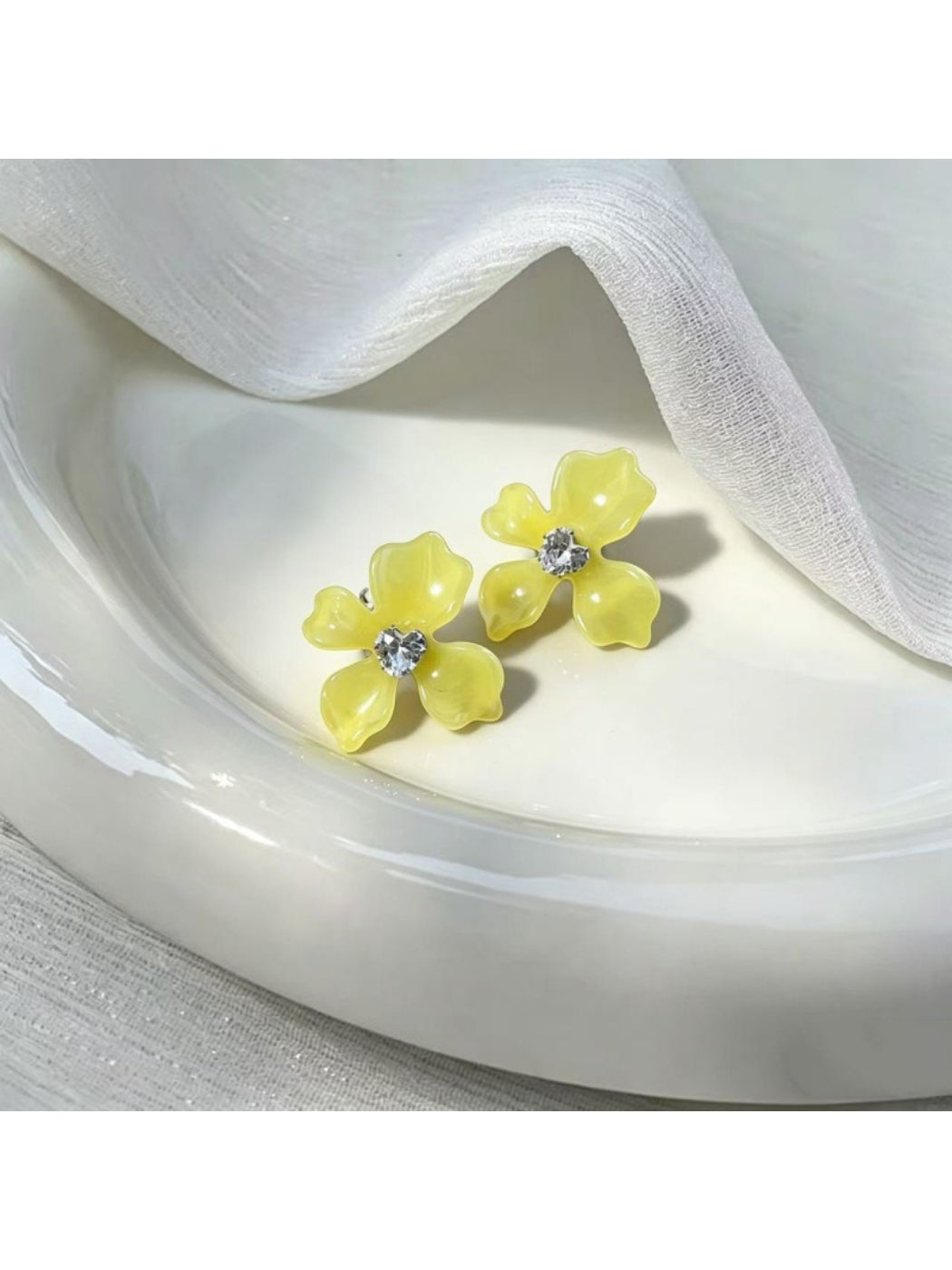 Close-up of Earwish floral stud earrings showing delicate pastel pink flower design
