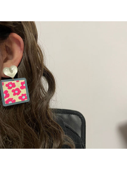 Close-up of Earwish Heart Top Floral Drop Earrings showing detailed pink flower and heart top