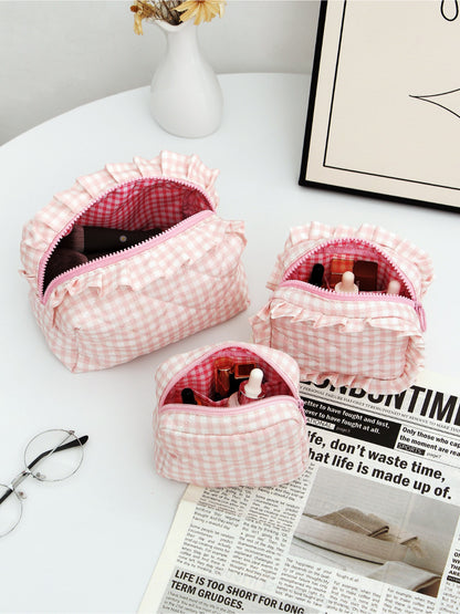 Cosbai checkered makeup pouch trio with ruffle trim with one pouch partially open