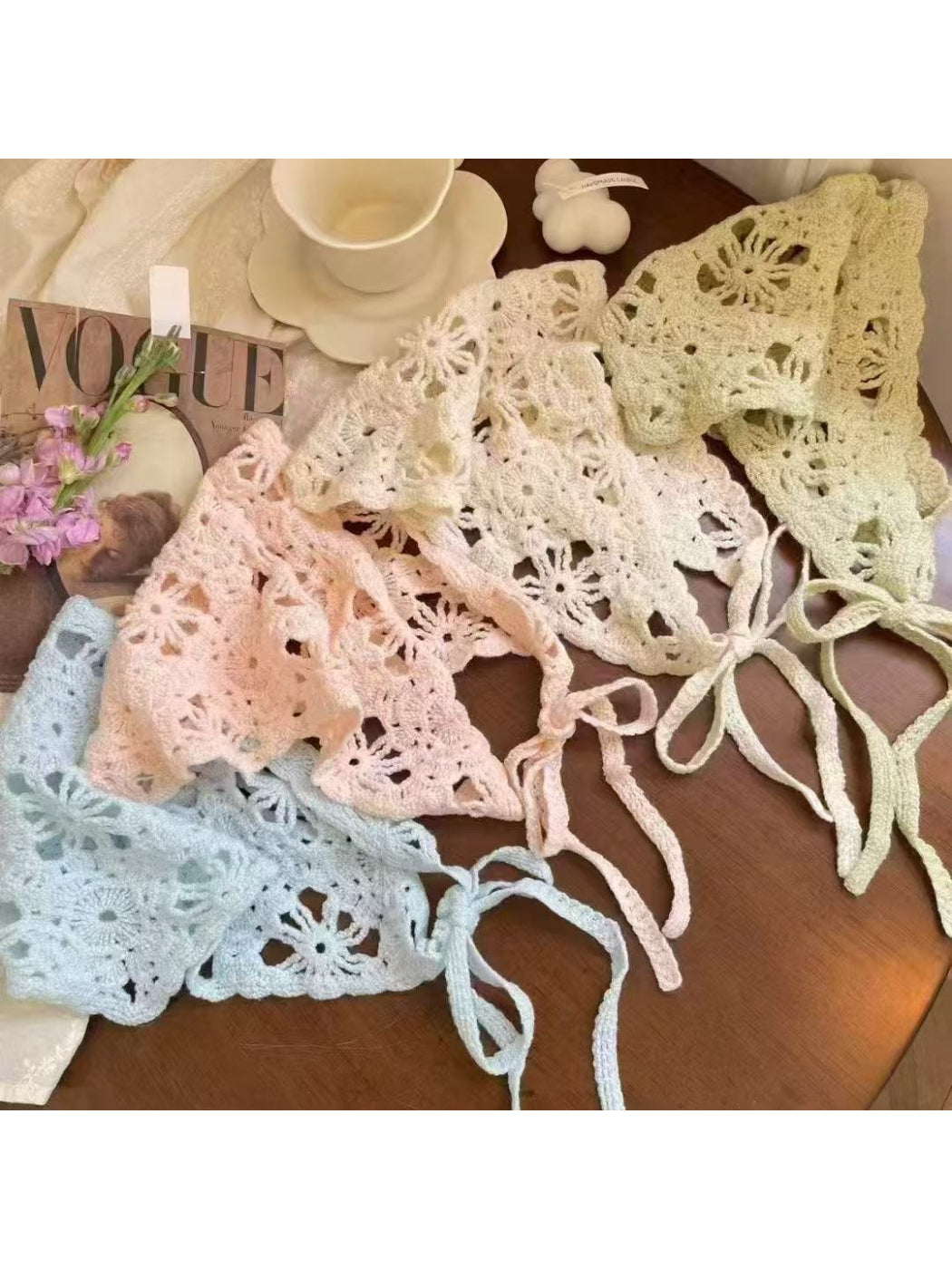 Boho open knit triangle scarf in cream color displayed flat