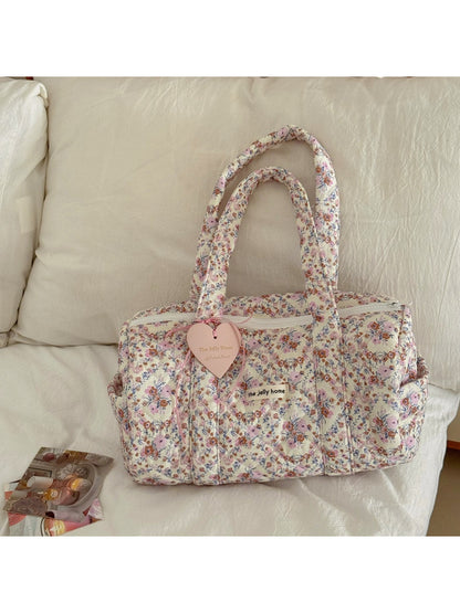 Side view of Cosbai Quilted Floral Duffle Bag showing quilted texture and handles