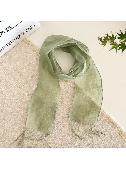Close-up of sheer fabric texture of solid color summer scarf showing fine weave