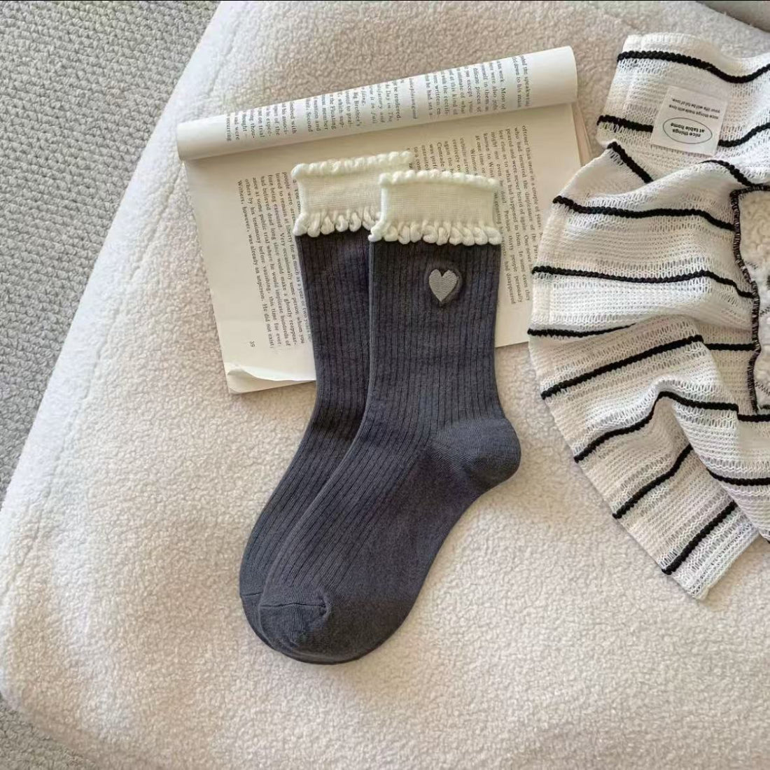 Rufia crew socks showing embroidered heart design on white sock material