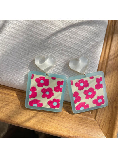 Pair of Earwish Heart Top Floral Drop Earrings displayed on white background showing full design