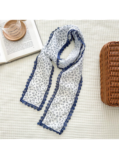 Close-up of floral pattern and lace trim on Scarvii skinny scarf