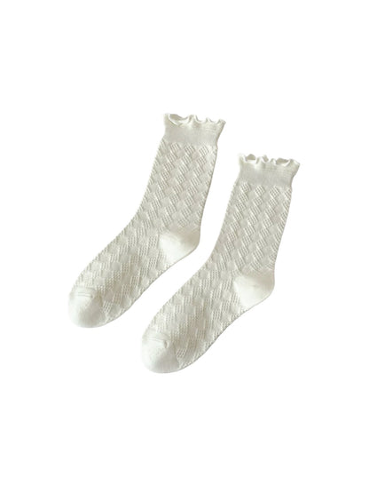 Rufia soft diamond pattern socks displayed on wooden surface