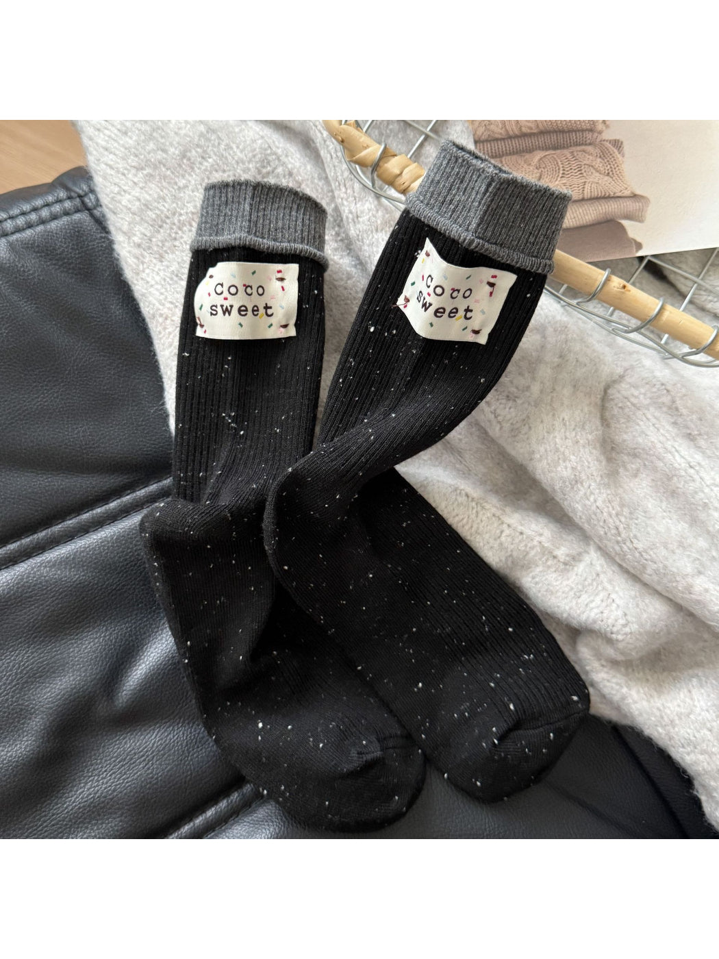 Side view of Rufia beige speckle knit crew sock highlighting ribbed cuff