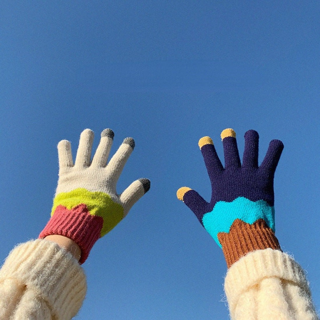 Pair of knitting patchwork touchscreen gloves displayed flat