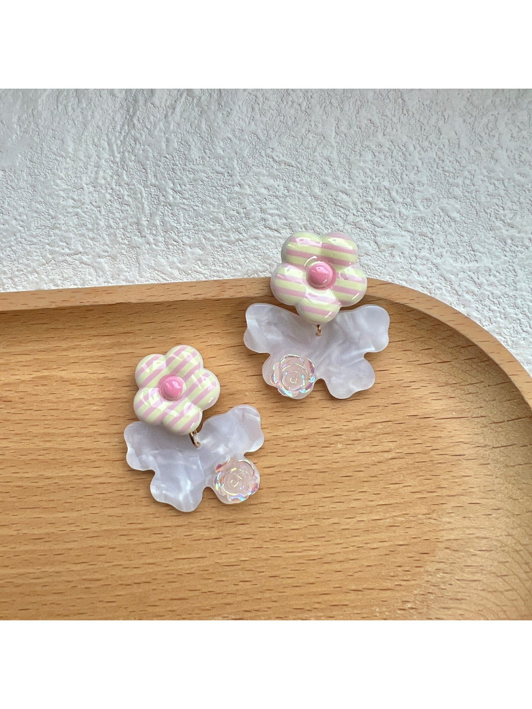Close-up of Earwish Stripe Flower Bow Earrings showing striped flower and bow design
