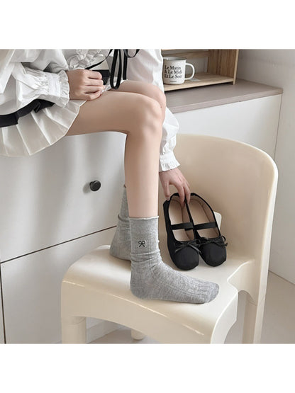 Rufia Tiny Ribbon Pointelle Socks displayed flat highlighting ribbed cuff and ribbon