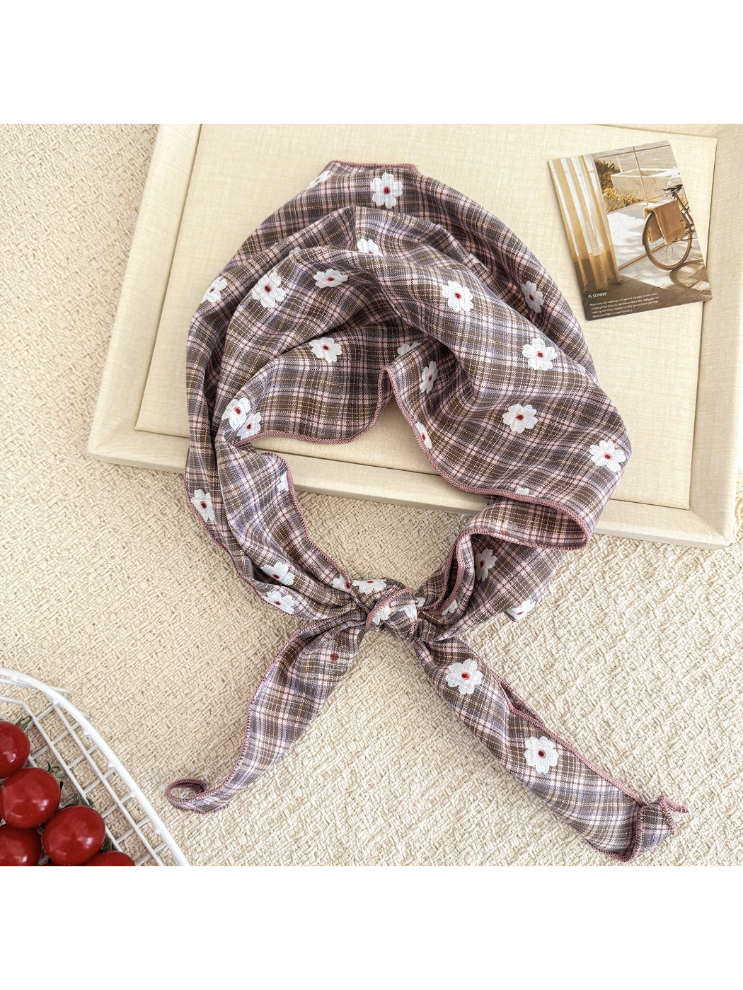 Model wearing soft plaid daisy hair tie scarf styled in a ponytail