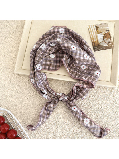 Model wearing soft plaid daisy hair tie scarf styled in a ponytail