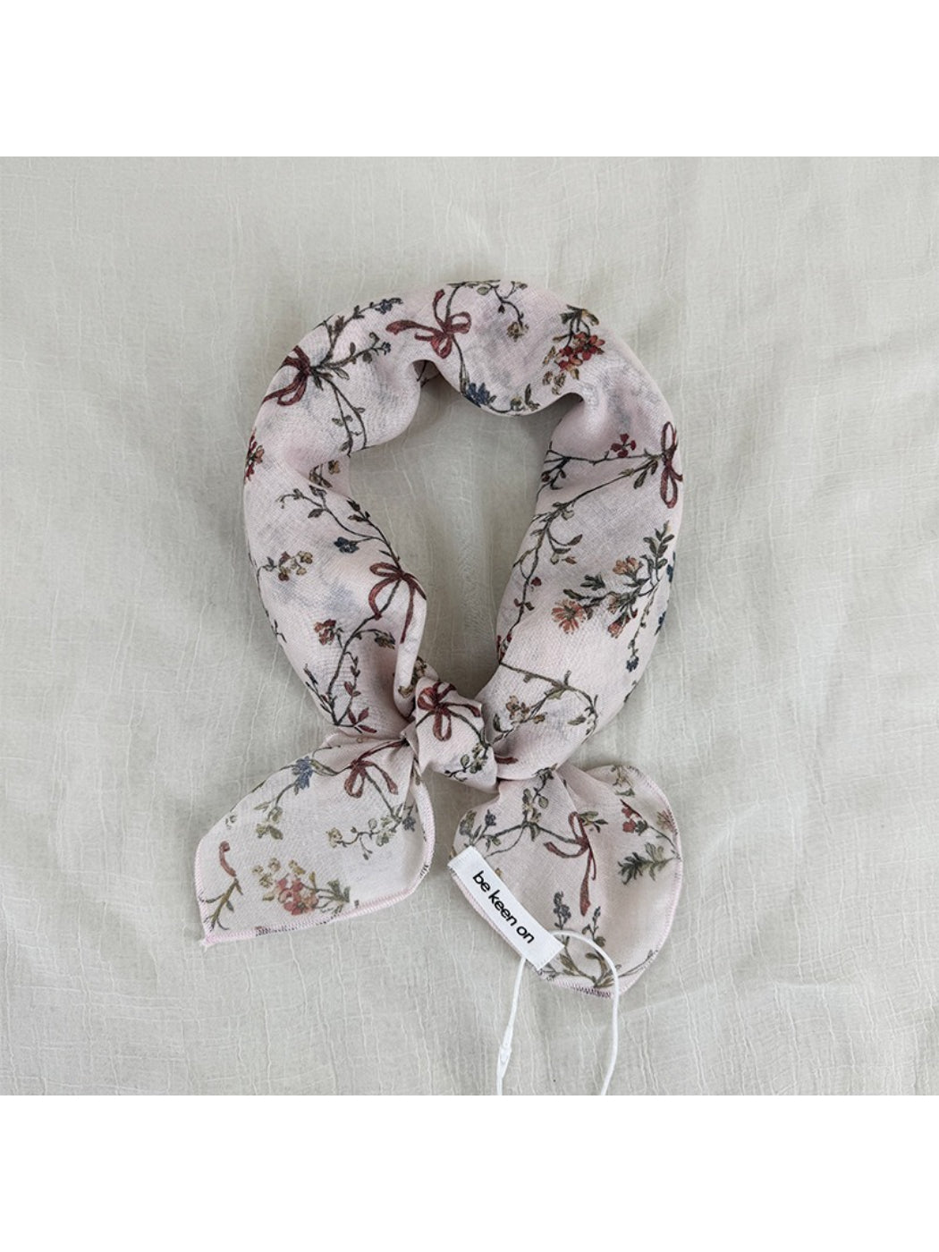 Close-up of Scarvii vintage floral scarf fabric with detailed pink and green floral design