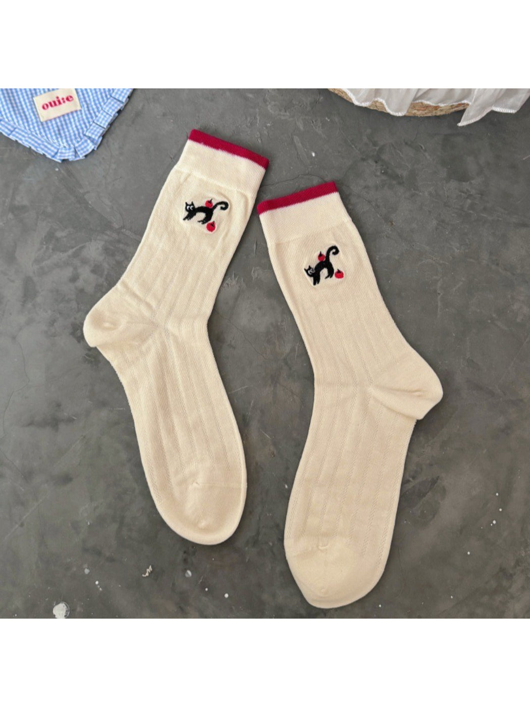 Close-up of sock fabric texture on Rufia black cat crew socks