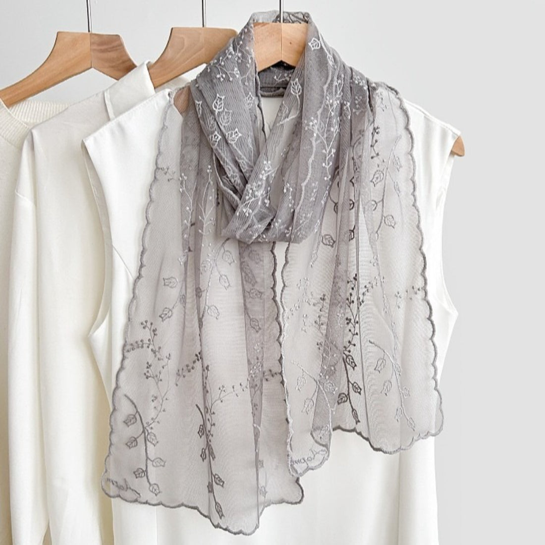 Model wearing the sheer embroidered scarf styled around the neck