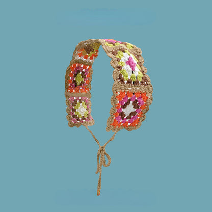 Scarvii crochet floral hairband featuring a mix of small and large crochet flowers