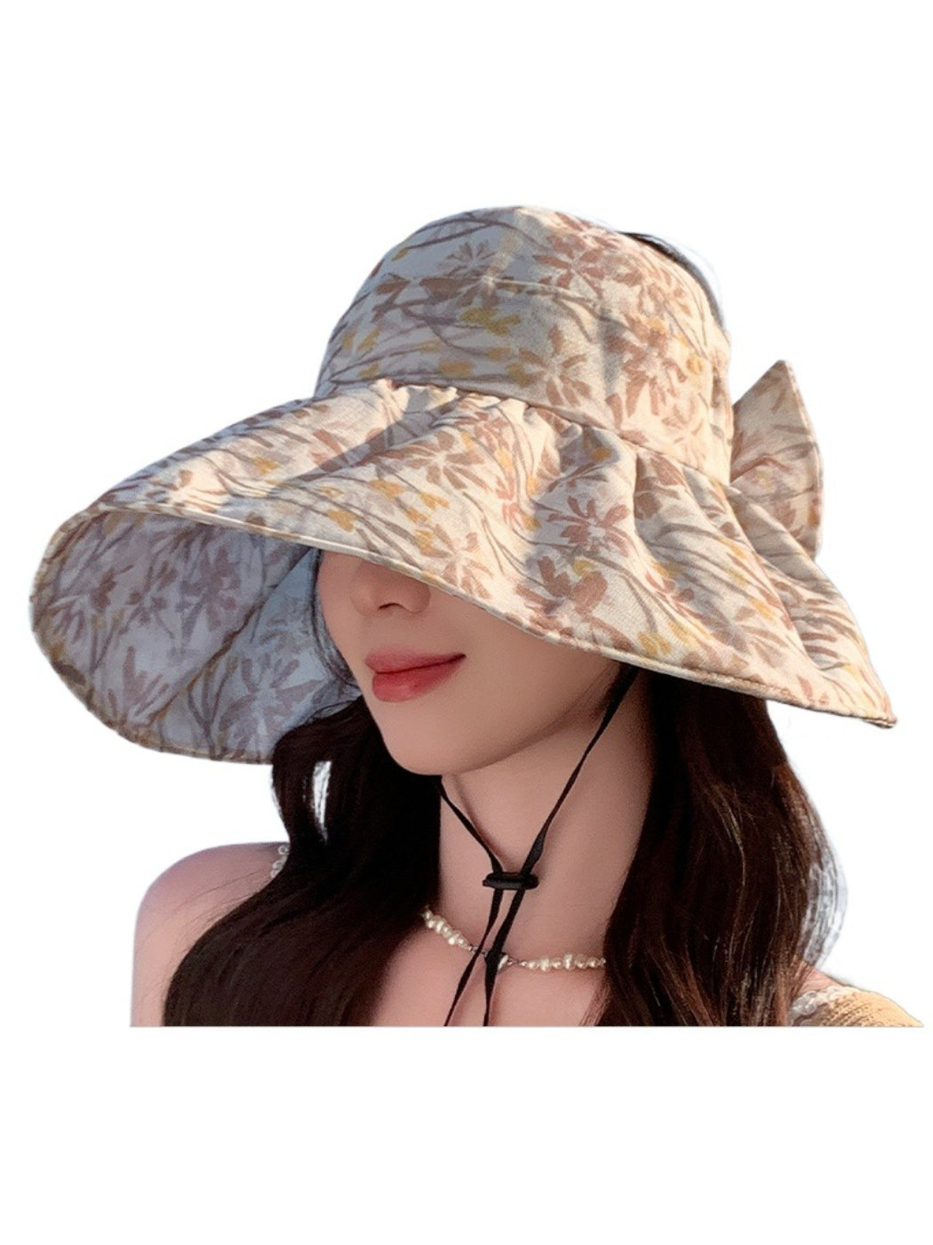 Pastel bloom wide brim hat displayed on white surface with soft shadows
