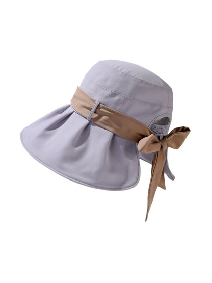 Model wearing Haila bow back pleated brim hat outdoors