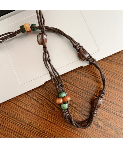 Slim beaded tie waist belt styled with casual outfit on model