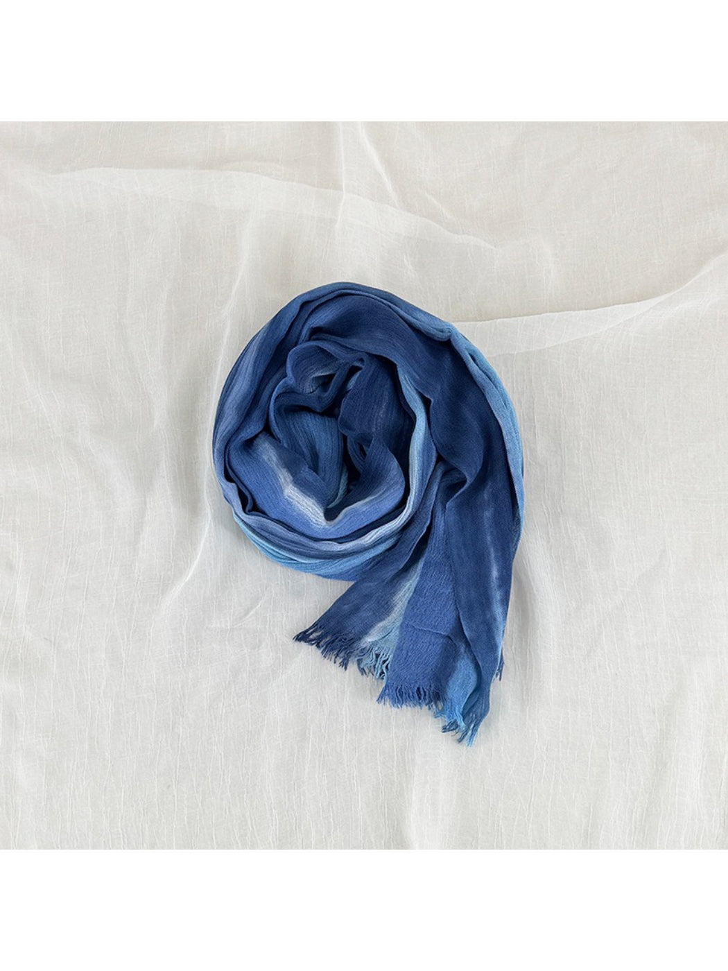 Model wearing Scarvii Painterly Blue frayed edge scarf styled around the neck