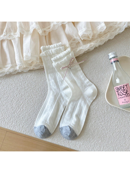 Side view of Rufia crew socks with check pattern and decorative ribbon