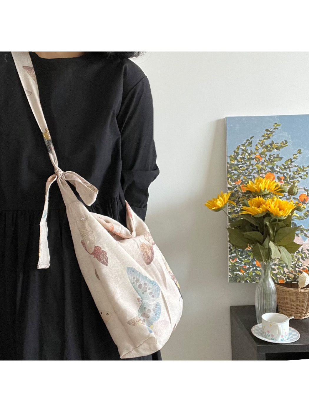Close-up of butterfly print fabric and tie detail on Cosbai shoulder bag