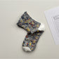 Rufia Heart White Mid-Calf Socks shown from top view highlighting cuff and heart design