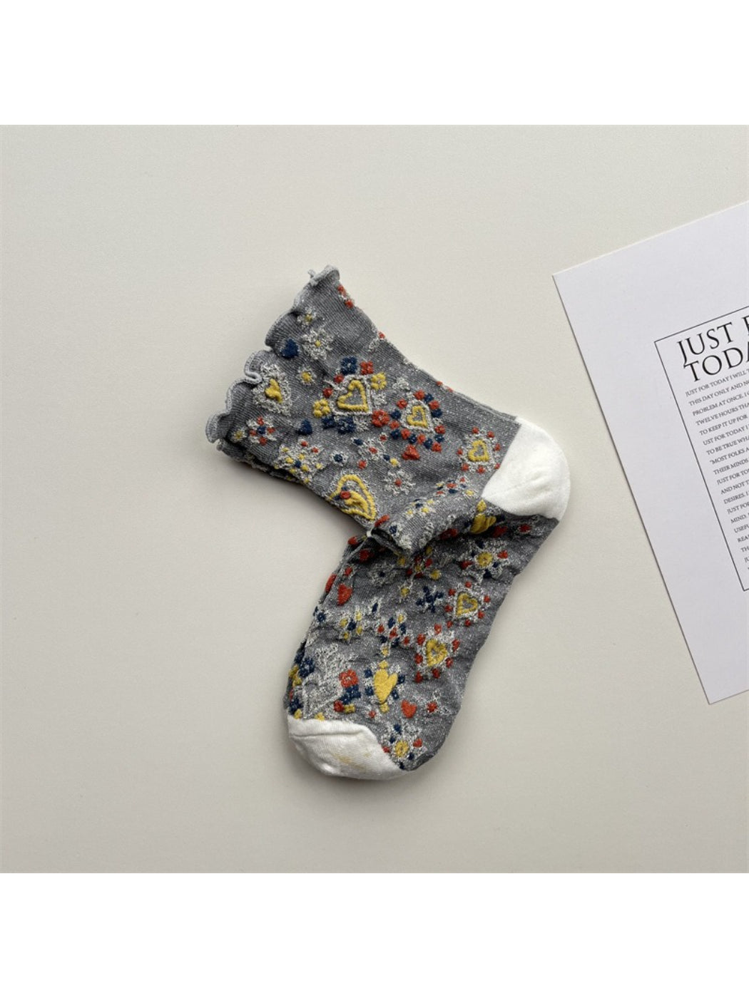 Rufia Heart White Mid-Calf Socks shown from top view highlighting cuff and heart design