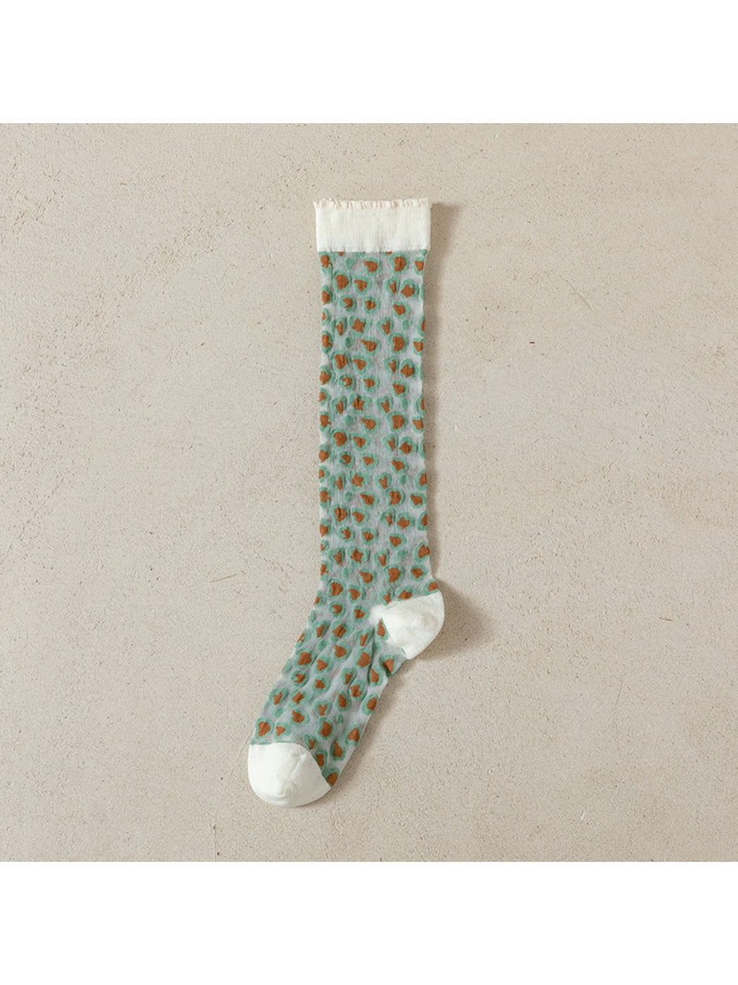 Rufia socks displayed on a wooden surface with soft light