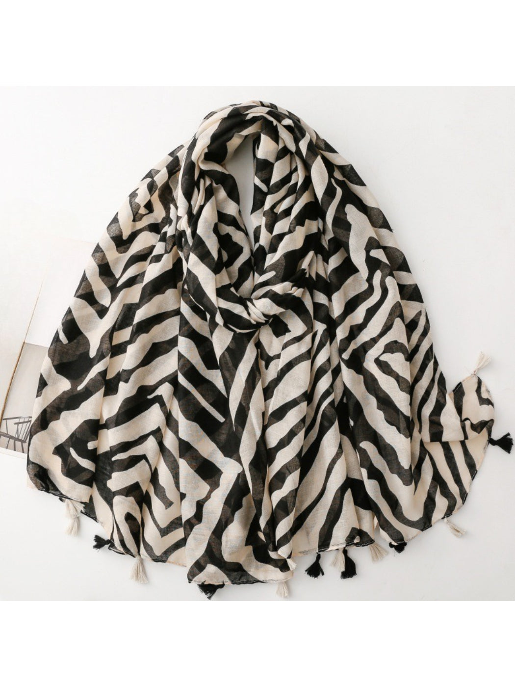 Scarvii Zebra Stripe Tassel Scarf folded showing black and white zebra pattern with tassels