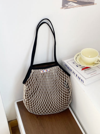 Cosbai beach tote bag displayed on sand with ocean background