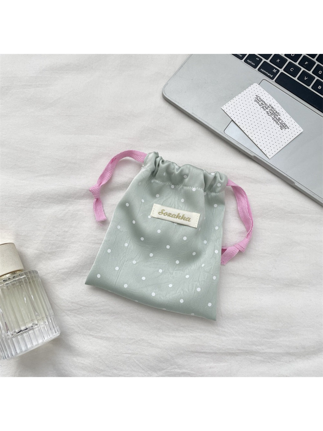 Cosbai Sweet Dot Drawstring Bag hanging on hook with drawstrings pulled