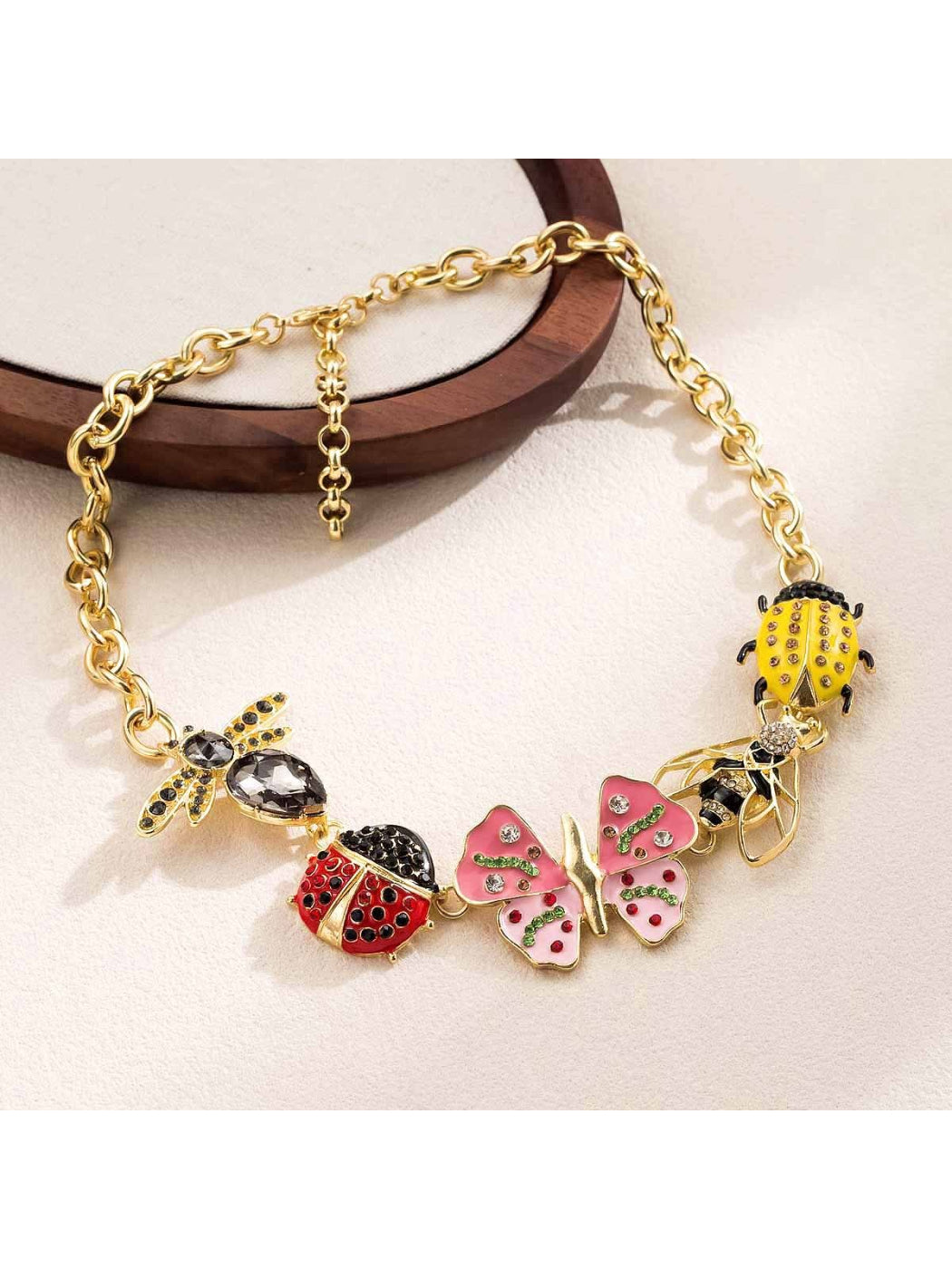 Neckit Butterfly & Bug Charm Necklace laid flat highlighting charm details and chain clasp