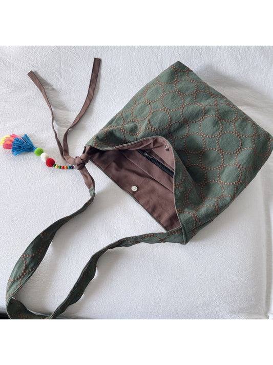Close-up of Cosbai tote bag showing detailed textured circle pattern on fabric
