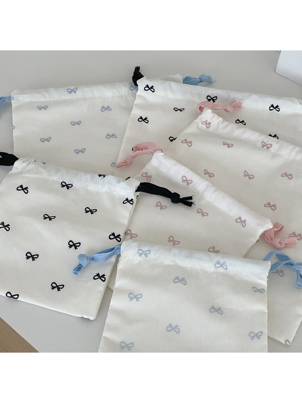 Cosbai drawstring pouch with bow pattern shown from above
