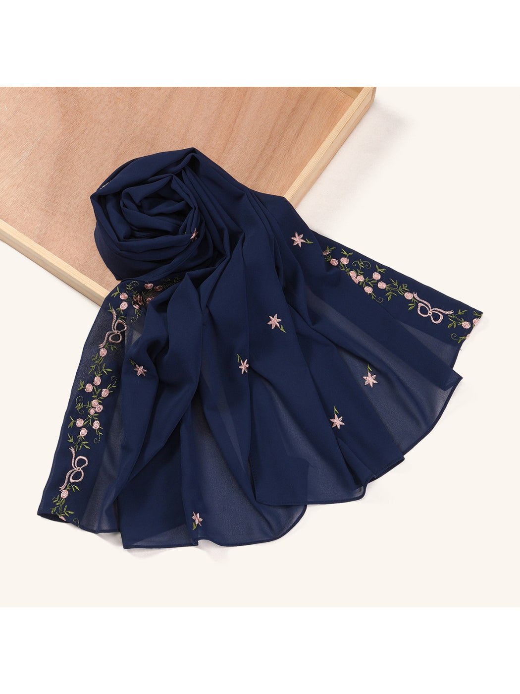 Scarf laid flat displaying full botanical embroidery pattern