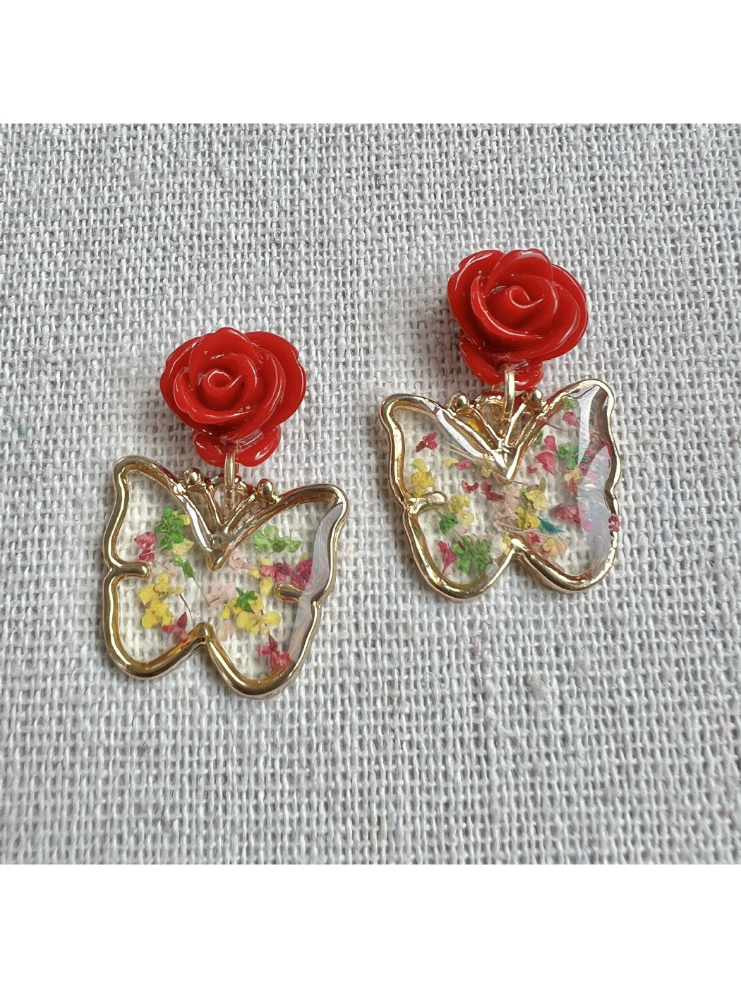 Model wearing Earwish Rose Butterfly Drop Earrings showcasing length and design