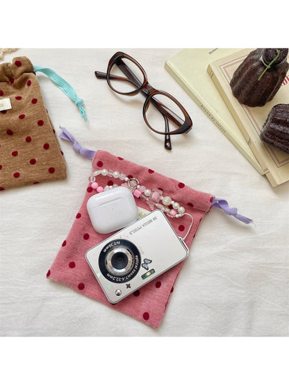 Cosbai velvet polka dot drawstring pouch folded flat with drawstrings visible