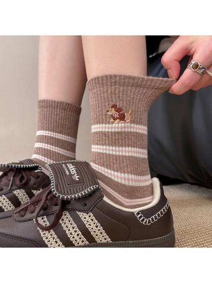 Close-up of Rufia crew socks with dog embroidery and horizontal stripes