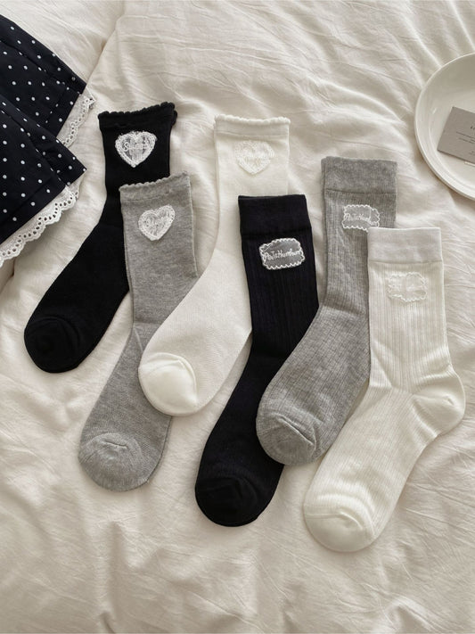 Close-up of Rufia Sweet Label logo embroidered on pink crew sock cuff