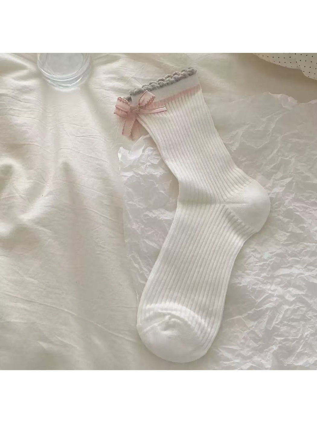 Rufia Romantic Bow Texture crew socks styled with a skirt and sneakers