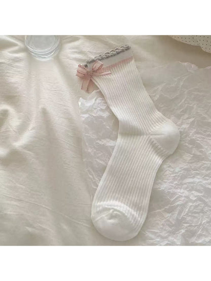 Rufia Romantic Bow Texture crew socks styled with a skirt and sneakers