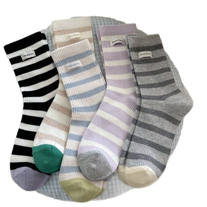 Side view of Rufia soft ribbed stripe crew socks on a model