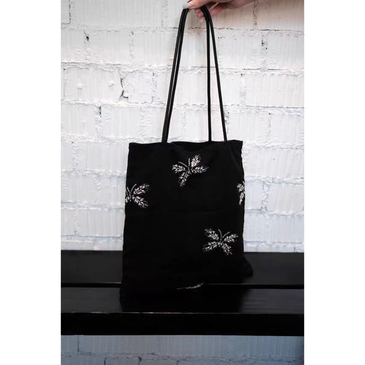 Black tote bag with intricate black beaded detailing on front
