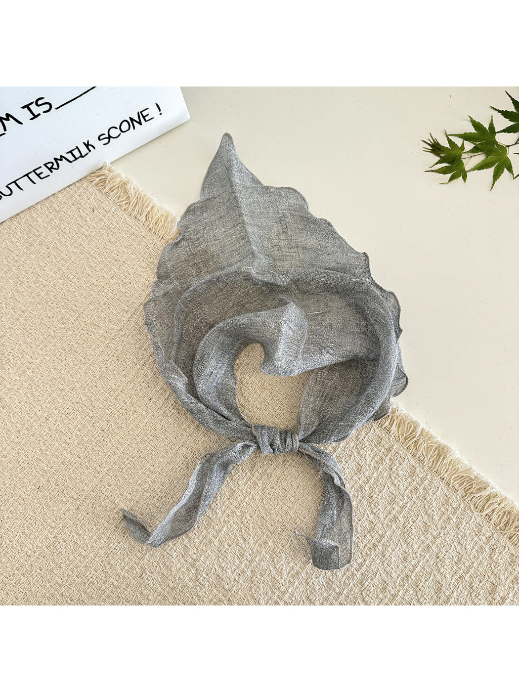 Close-up of the sheer fabric texture of the solid triangle scarf